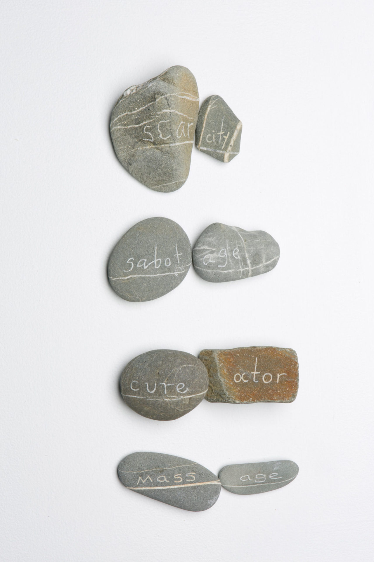 Rock Poem - Scarcity 2013 engraved beach stone with cross contour of quartz